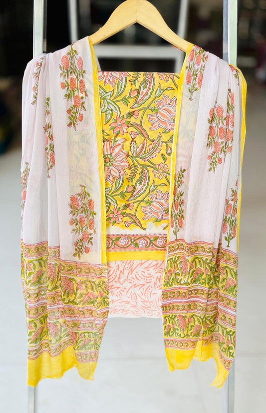 Floral patterned dress with yellow accents on a hanger