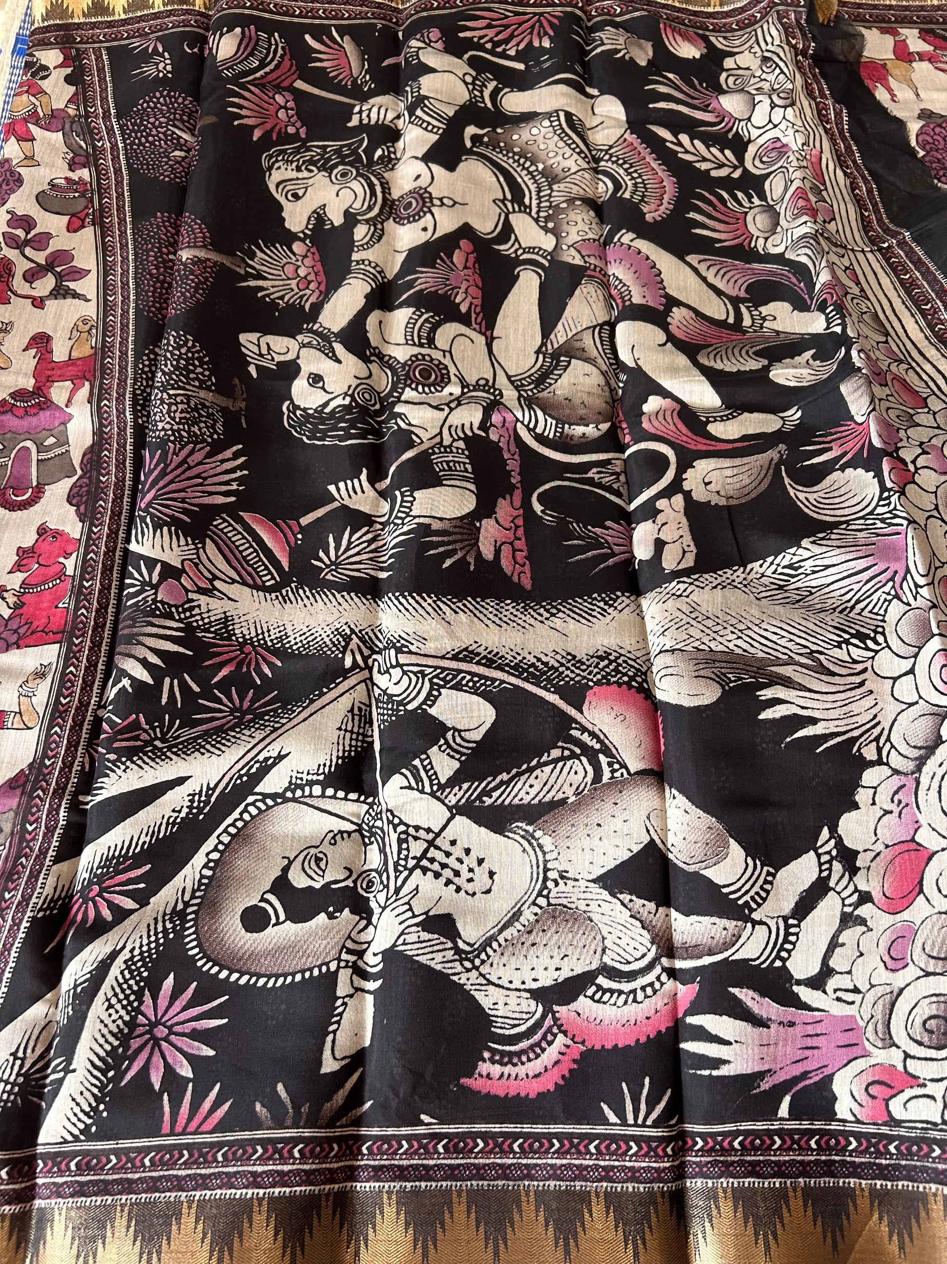 Decorative fabric with intricate patterns and colors, featuring figures and abstract designs.