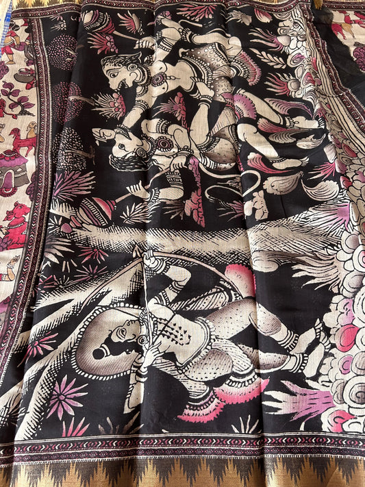 Decorative fabric with intricate patterns and colors, featuring figures and abstract designs.