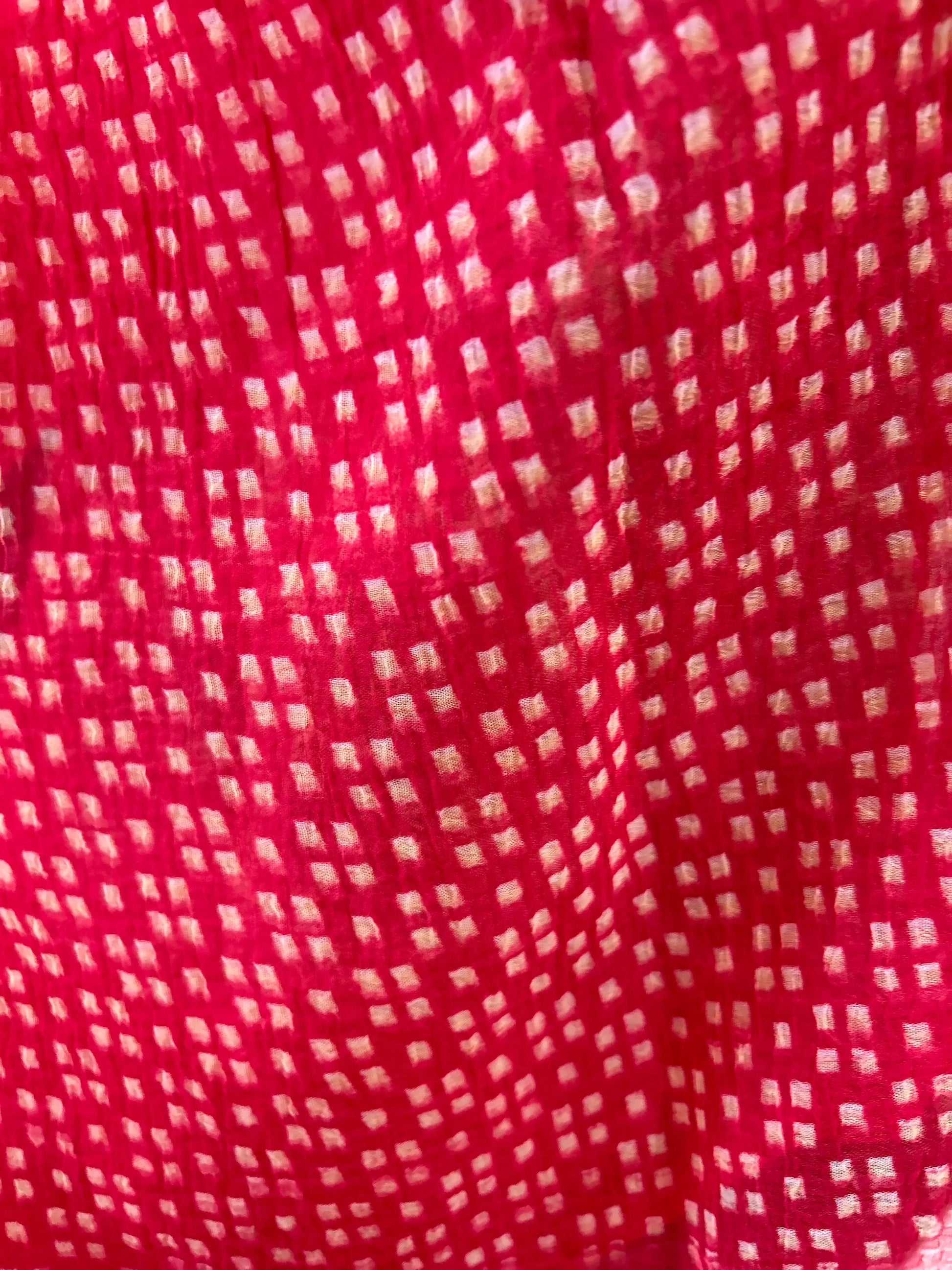 Red fabric with a small white pattern