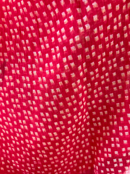 Red fabric with a small white pattern