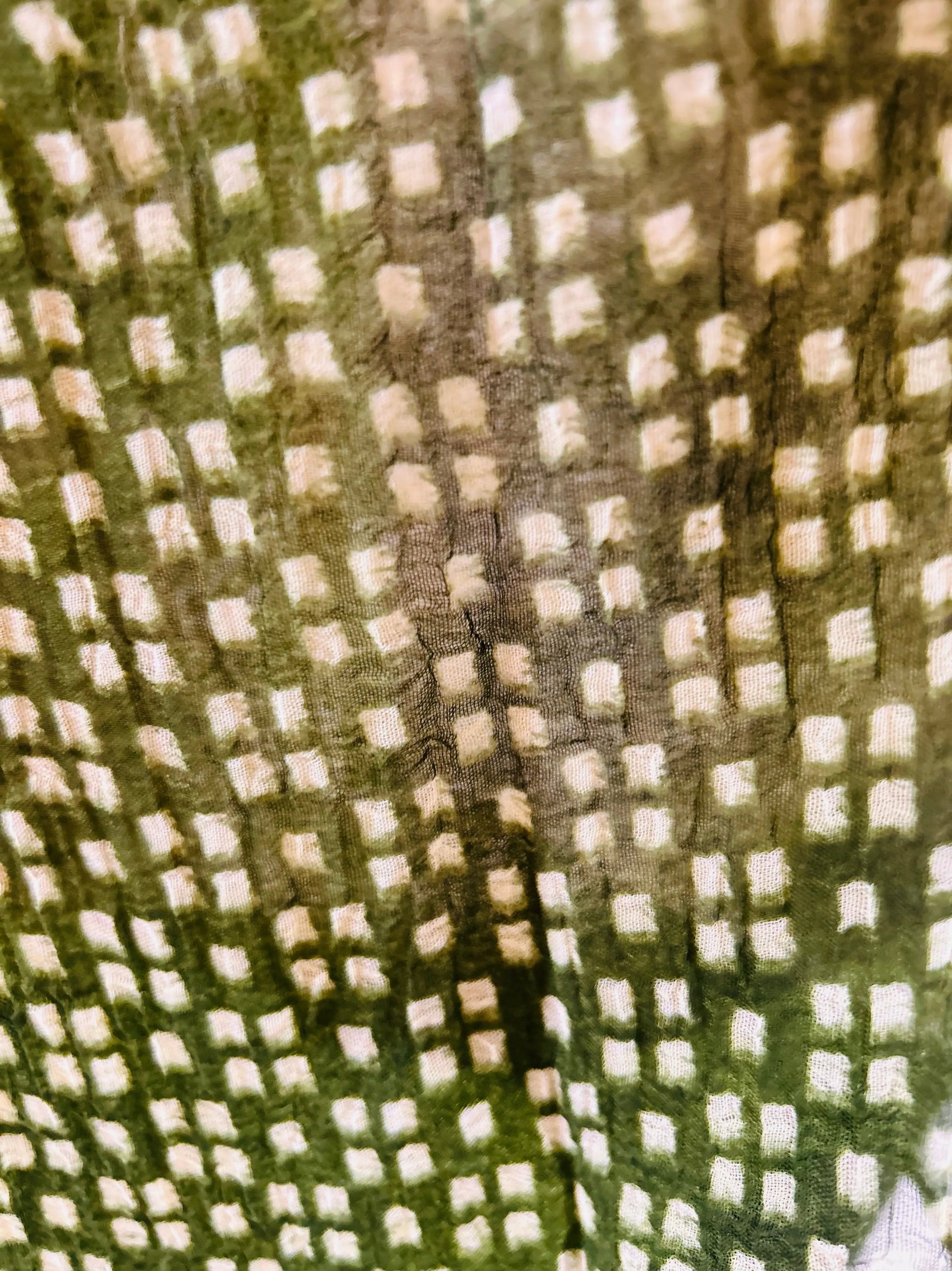 green fabric with a checkered pattern
