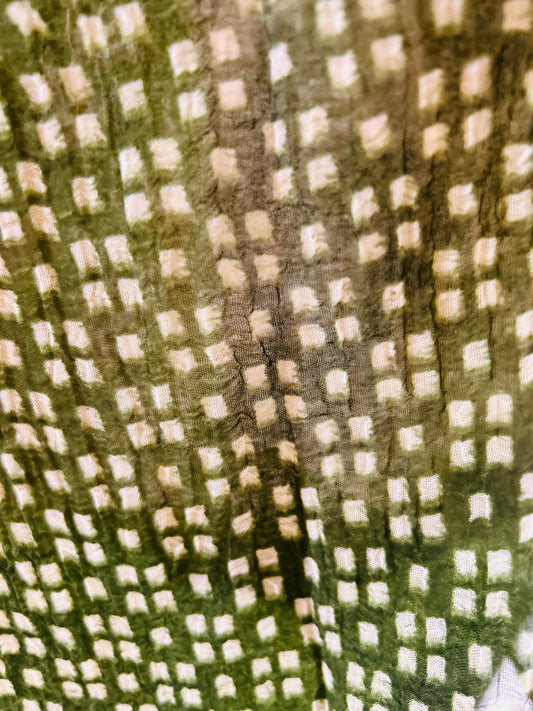green fabric with a checkered pattern