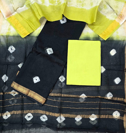 Black saree with white patterns and yellow blouse on a checkered background